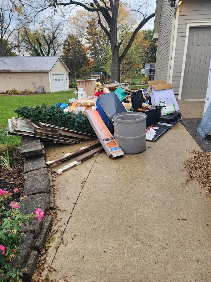 Dumpster being loaded with debris for 12 Yard Dumpster Rental in Swannanoa